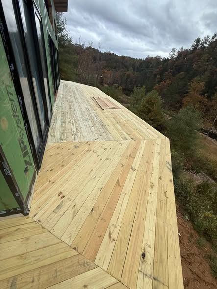 New angled wooden deck on a hillside home