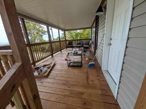 Covered porch with new deck boards and railing