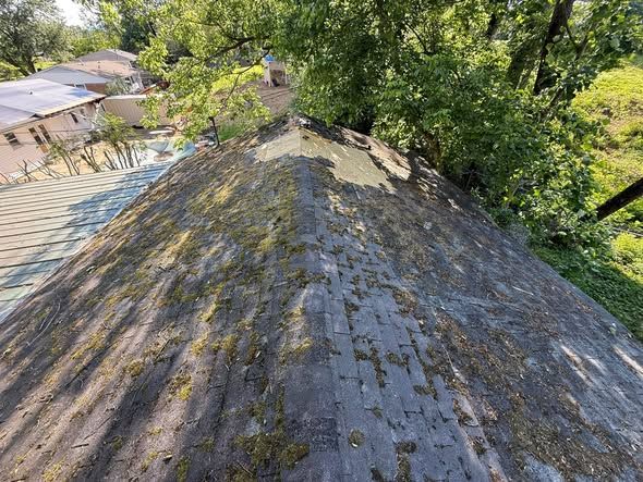 Worn, mossy shingle roof before replacement