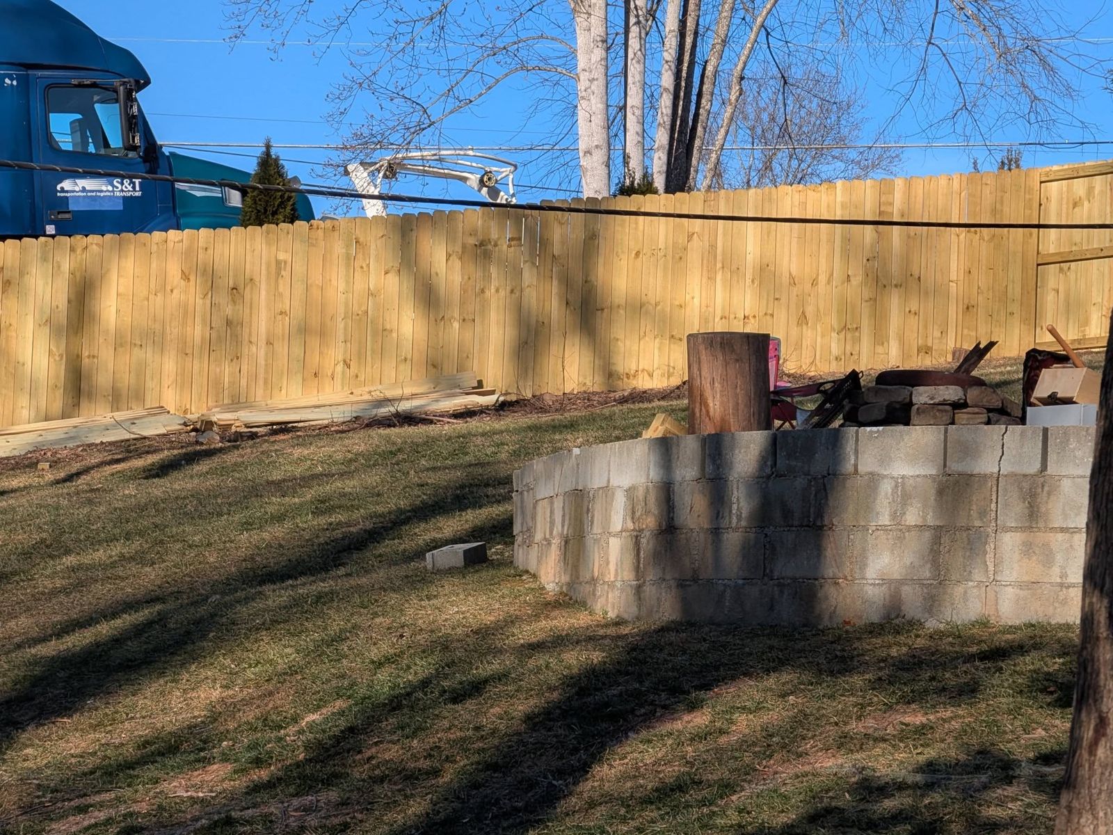 New wooden privacy fence around a backyard