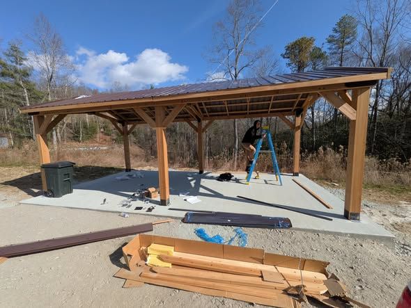 Installing the metal roof on a timber pavilion